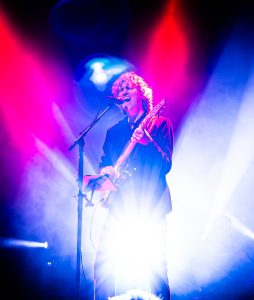 Ben Goddard of Fleetwood Unchained on stage as Lindsey Buckingham